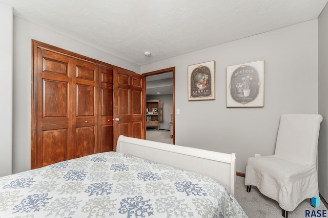 carpeted bedroom with a textured ceiling