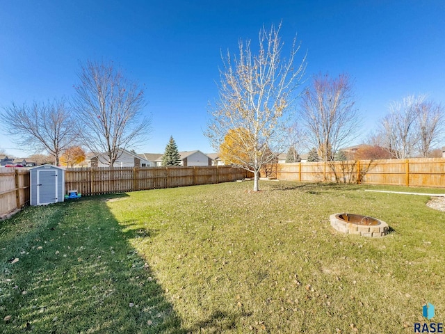 view of yard featuring a storage unit and a fire pit