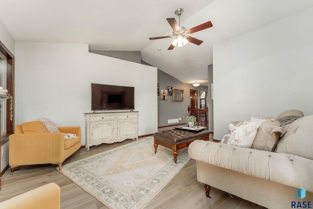 living room featuring vaulted ceiling, ceiling fan, and light hardwood / wood-style flooring