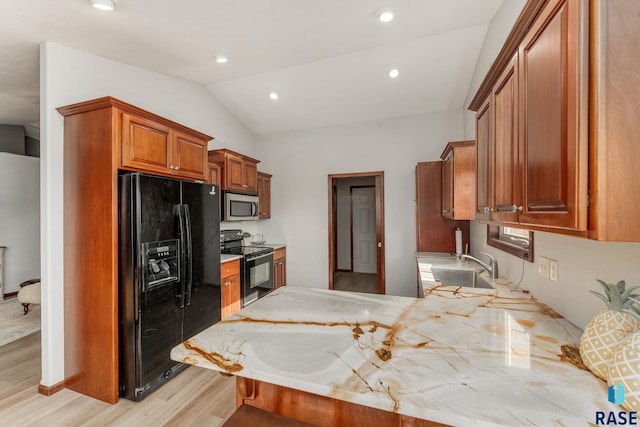 kitchen with lofted ceiling, sink, light hardwood / wood-style flooring, black appliances, and kitchen peninsula