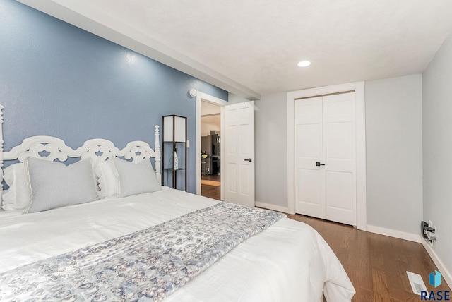 bedroom with hardwood / wood-style flooring and a closet