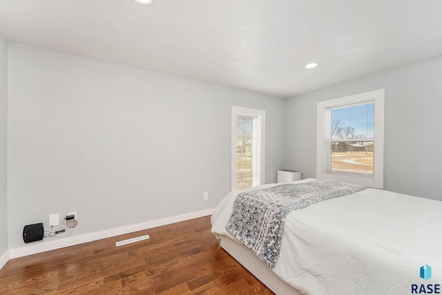 bedroom with dark wood-type flooring