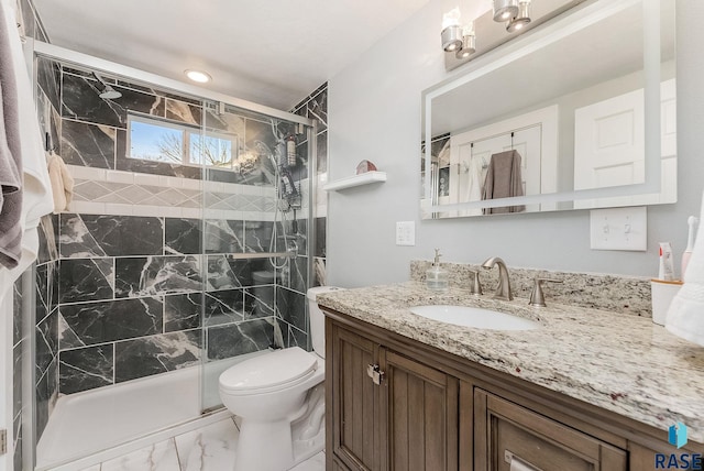 bathroom featuring vanity, toilet, and walk in shower