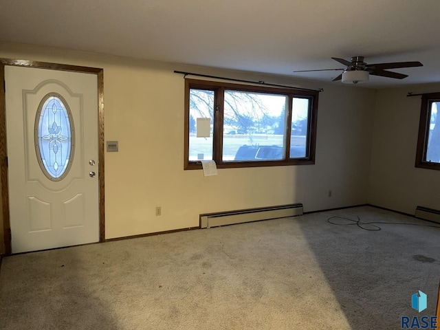 foyer featuring light colored carpet and baseboard heating