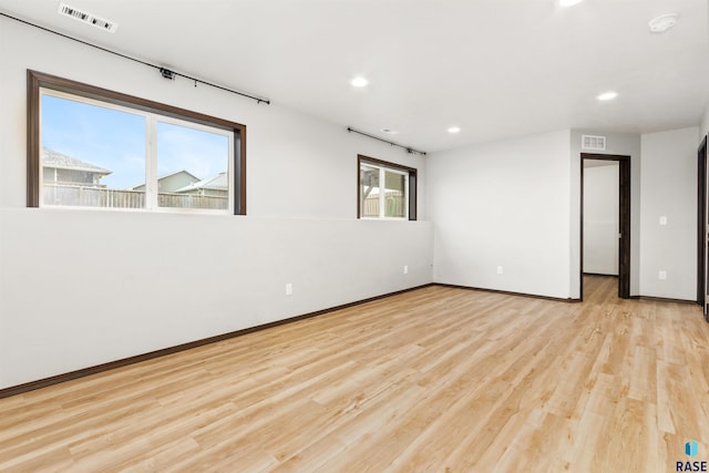 spare room featuring light hardwood / wood-style floors