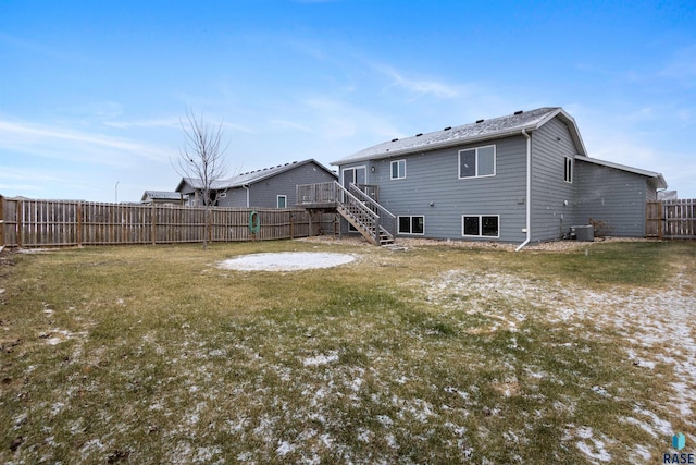 rear view of house with a yard and central AC unit