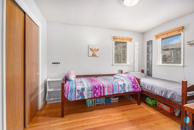 bedroom featuring light hardwood / wood-style floors and a closet