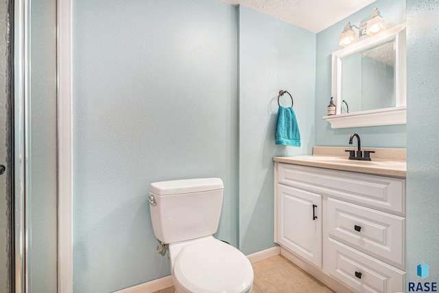 bathroom with vanity, tile patterned floors, and toilet