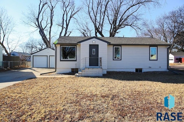 view of front of property featuring a garage and an outbuilding