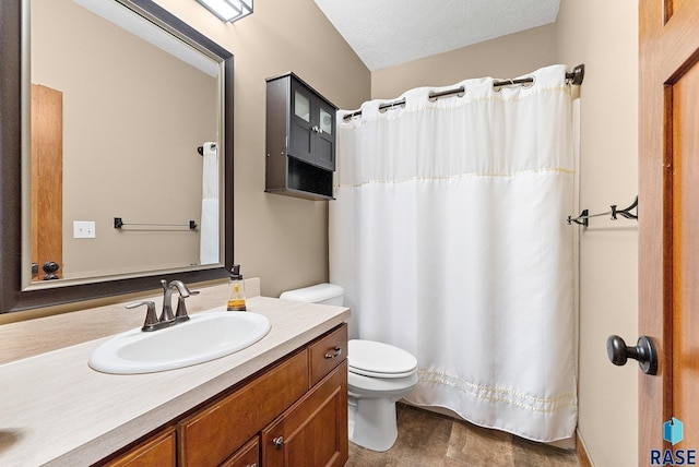 bathroom featuring vanity, a textured ceiling, and toilet