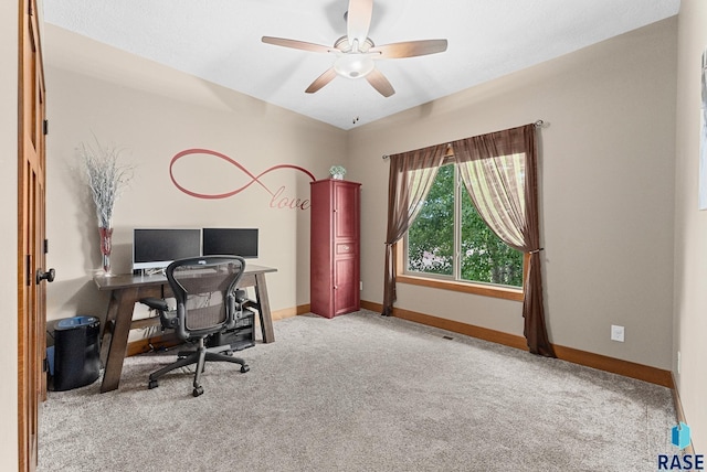 carpeted office space with ceiling fan