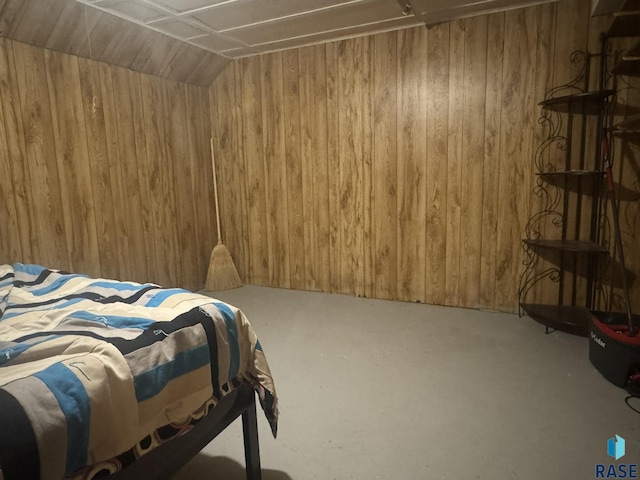 bedroom featuring wooden walls