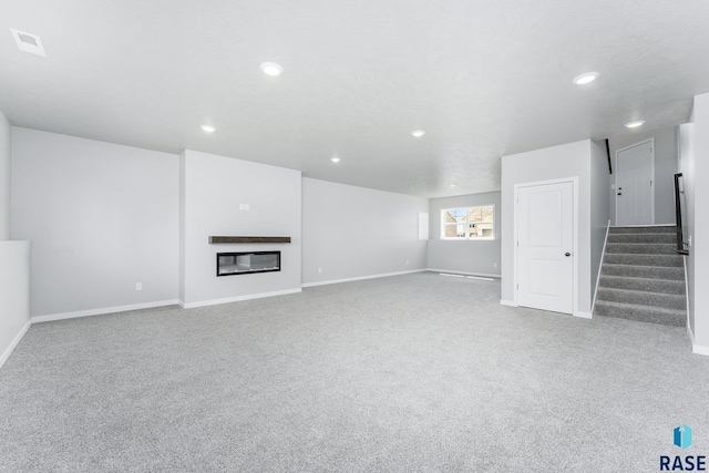 unfurnished living room with light carpet