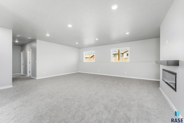 unfurnished living room featuring light carpet