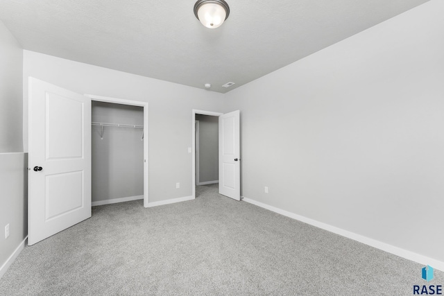 unfurnished bedroom featuring carpet and a closet