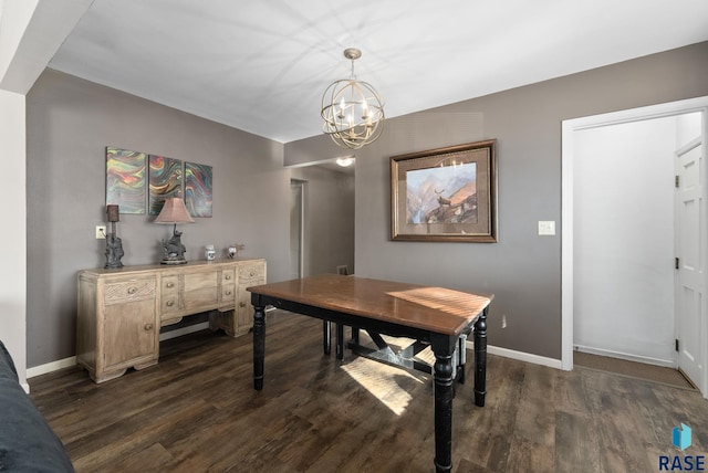 dining space with dark wood-type flooring and a notable chandelier