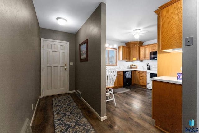 doorway with ceiling fan and dark hardwood / wood-style flooring