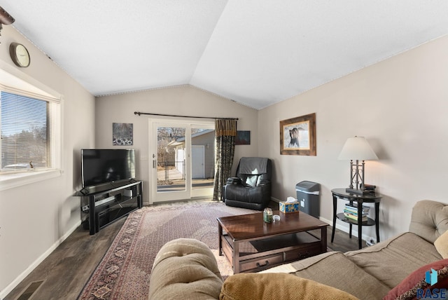 living room featuring lofted ceiling, dark hardwood / wood-style flooring, and a wealth of natural light