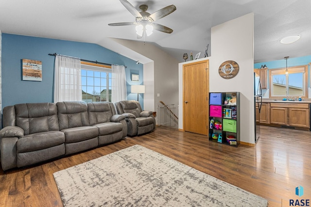 living room featuring lofted ceiling, dark hardwood / wood-style floors, and ceiling fan