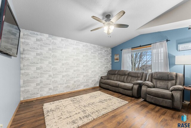 living room with vaulted ceiling, dark wood-type flooring, and ceiling fan