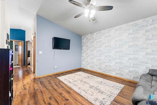 living room featuring vaulted ceiling, ceiling fan, and hardwood / wood-style floors