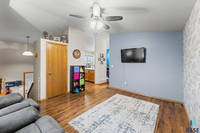 living room featuring ceiling fan and wood-type flooring