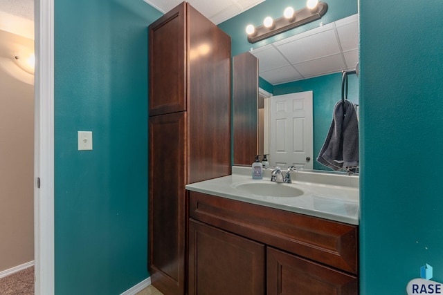 bathroom with vanity and a drop ceiling