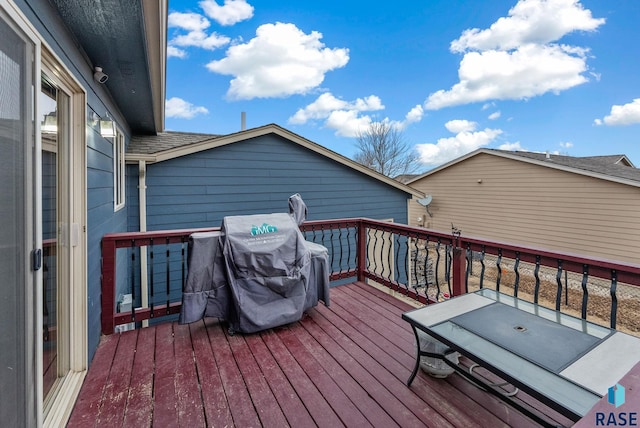 wooden terrace featuring grilling area