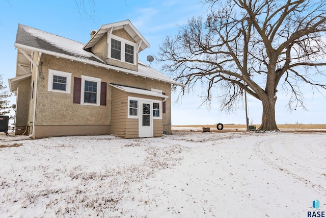 snow covered property featuring central air condition unit