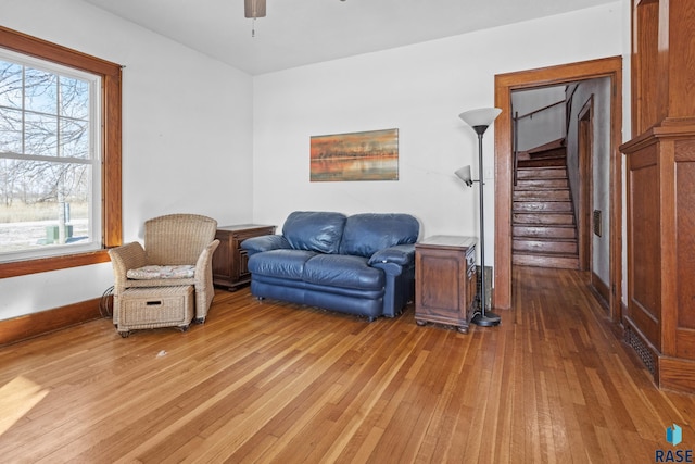 living area with hardwood / wood-style floors and ceiling fan