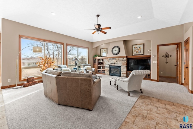 living room with light carpet, a tray ceiling, and ceiling fan