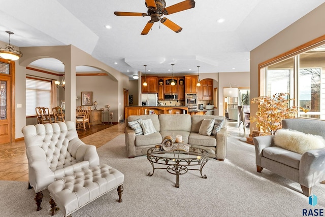 living room with light carpet and ceiling fan