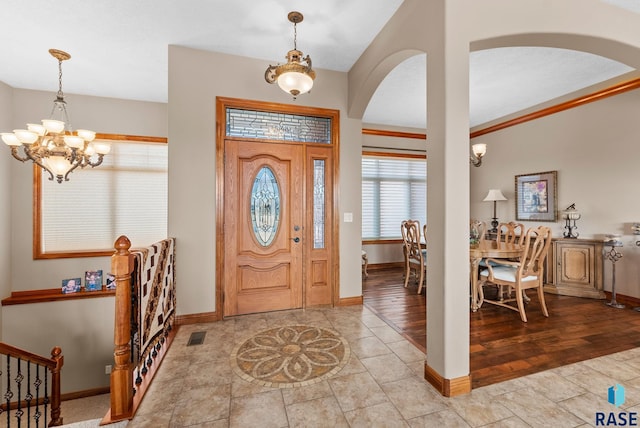 foyer entrance featuring a notable chandelier