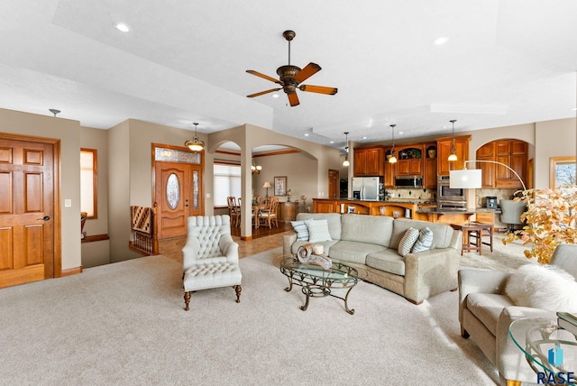 living room with light colored carpet and ceiling fan