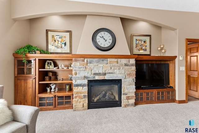 living room featuring a fireplace and carpet