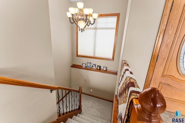 staircase featuring carpet and a notable chandelier