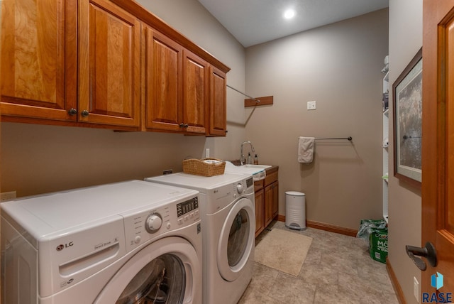 washroom featuring independent washer and dryer, cabinets, and sink