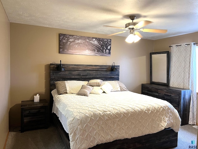 bedroom featuring ceiling fan, carpet floors, and a textured ceiling