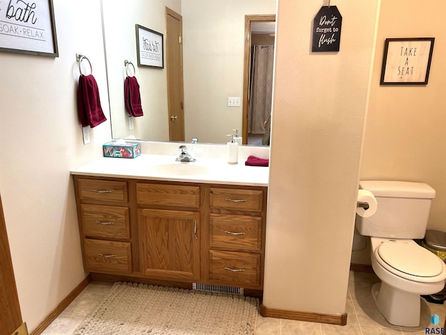 bathroom featuring tile patterned floors, vanity, and toilet