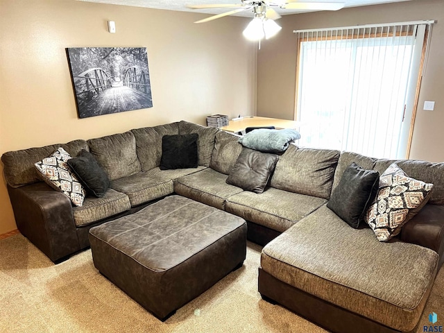 living room with ceiling fan and light colored carpet