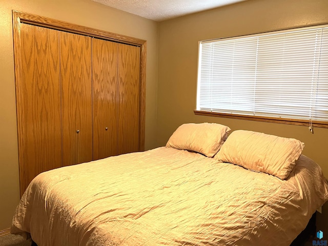 bedroom with a closet and a textured ceiling