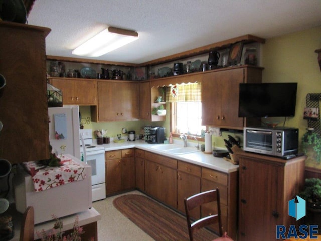 kitchen with sink and white electric range oven