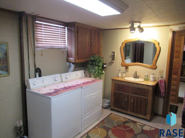 laundry room with separate washer and dryer and sink