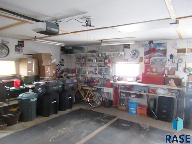 garage with a garage door opener and a workshop area