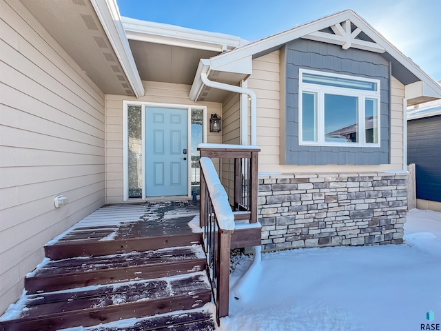 view of snow covered property entrance