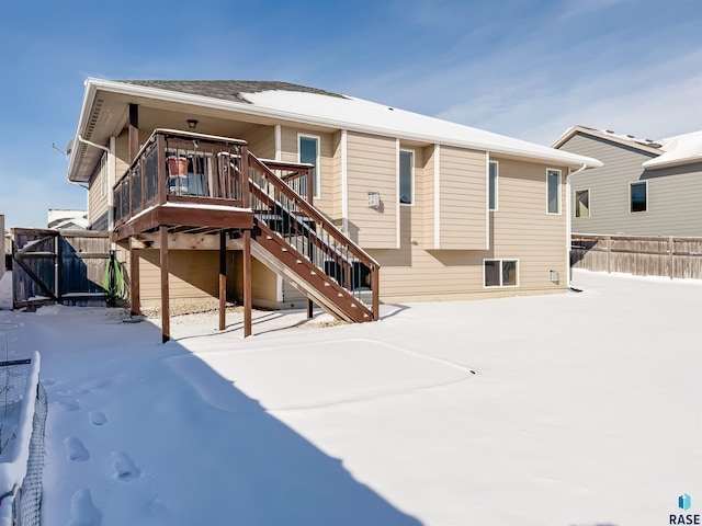 view of snow covered back of property