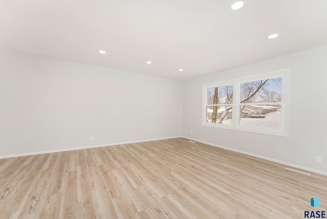 spare room featuring light hardwood / wood-style flooring