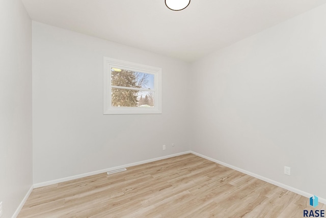 spare room with light hardwood / wood-style floors