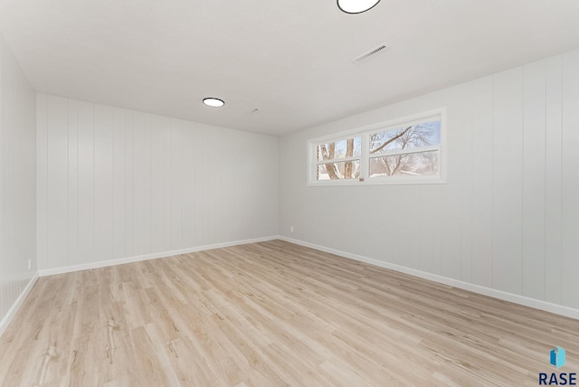 spare room featuring light hardwood / wood-style floors