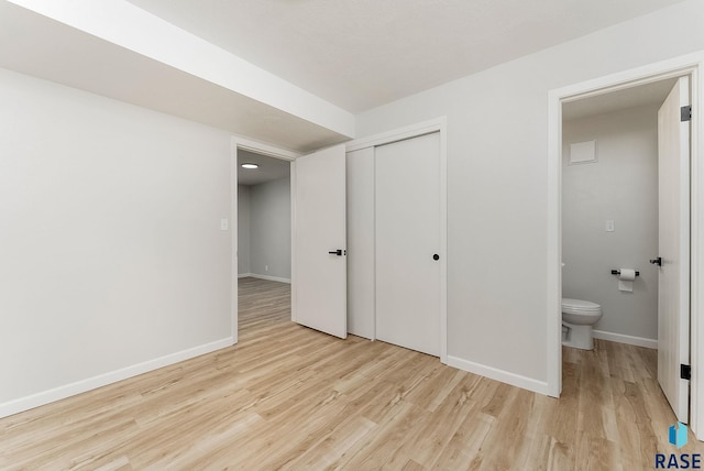 unfurnished bedroom featuring a closet and light hardwood / wood-style flooring